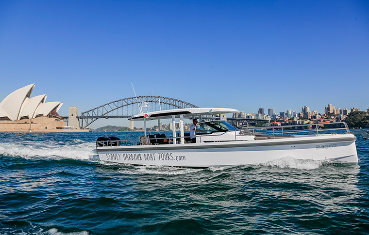 Boat cruises in front of Sydney Harbour Bridge