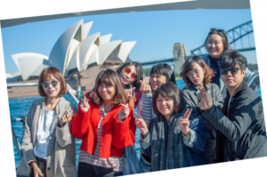 Travel agents from China tour the Sydney Harbour and pose in front of Sydney Opera House.